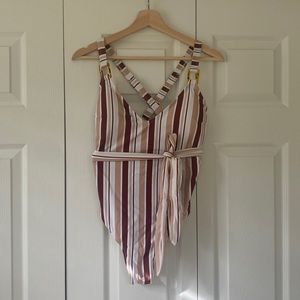 One piece Cupshe bathing suit with removable wrap that ties at waist.